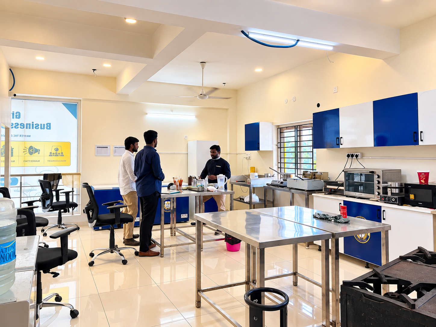 Trainees gathered around a steel work table in the Fine Dine Academy training kitchen