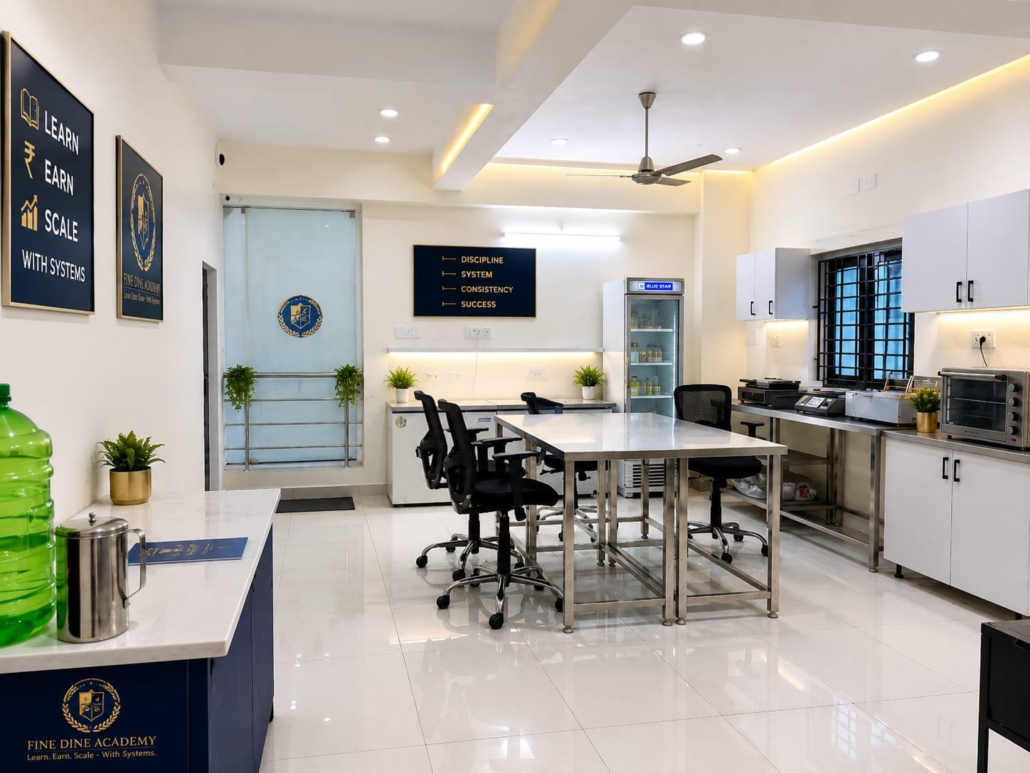 Fine Dine Academy kitchen training area with stainless-steel worktables